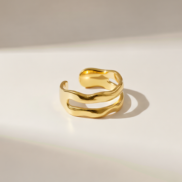 Gold open ring on a light beige background