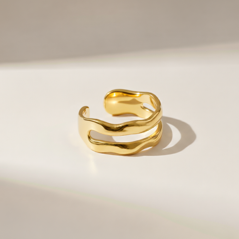 Gold open ring on a light beige background