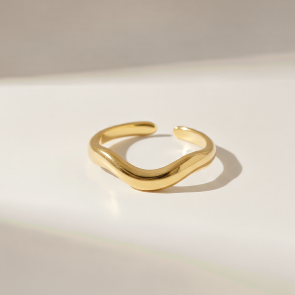 Gold ring on a light beige background