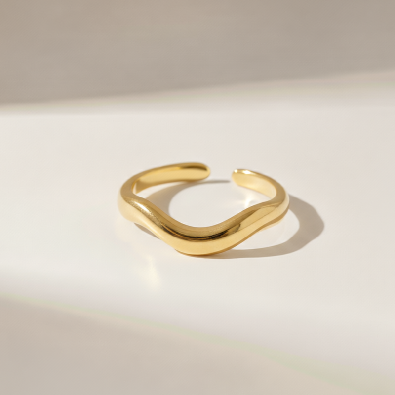 Gold ring on a light beige background