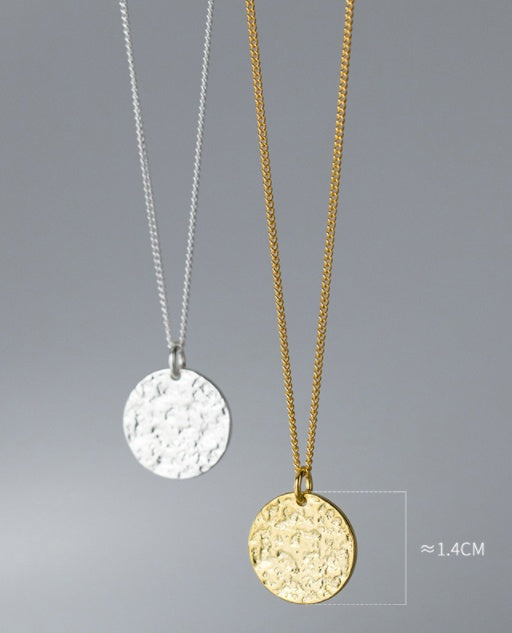 Two necklaces with round pendants on gray background